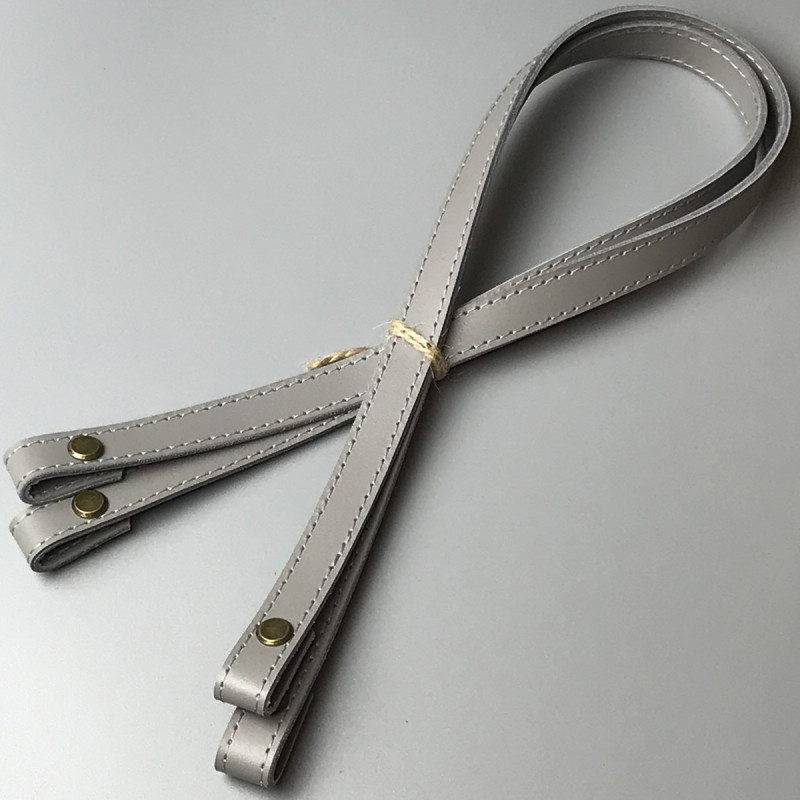 Light grey leather handles with bend on screws, 67×1.5 cm